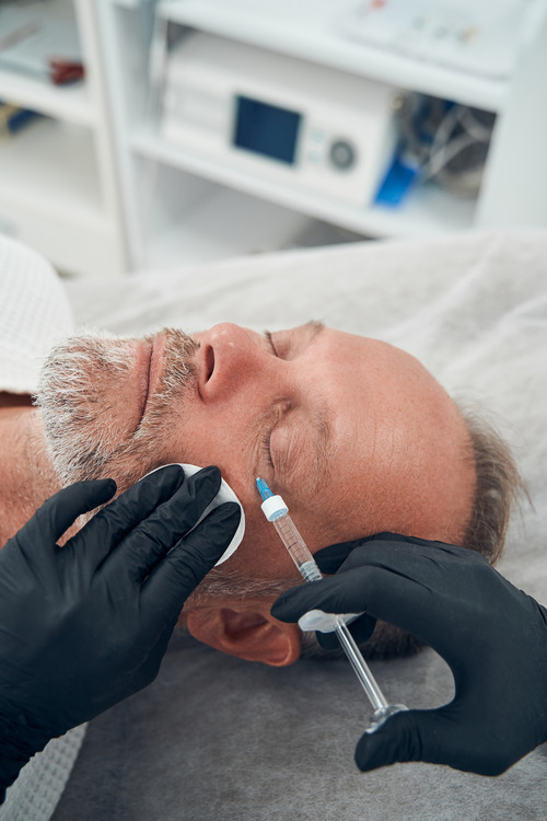 man having anti aging injection procedure in cosme man having anti aging injection procedure in cosme
