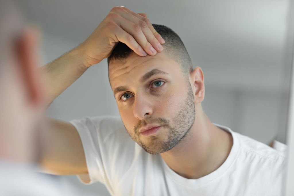 Man checking face in mirror